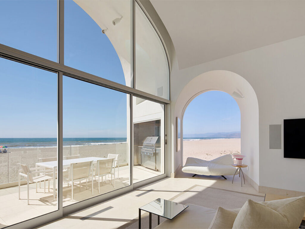 Beach house floor to ceiling windows with views of the ocean