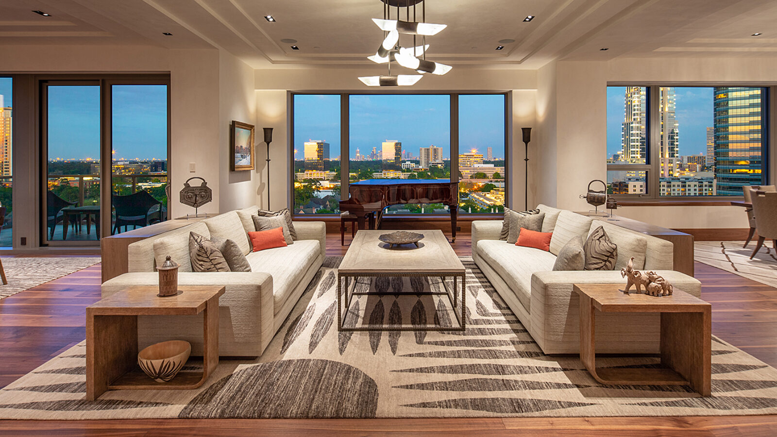 Open concept living room with views of the city through floor to celling windows