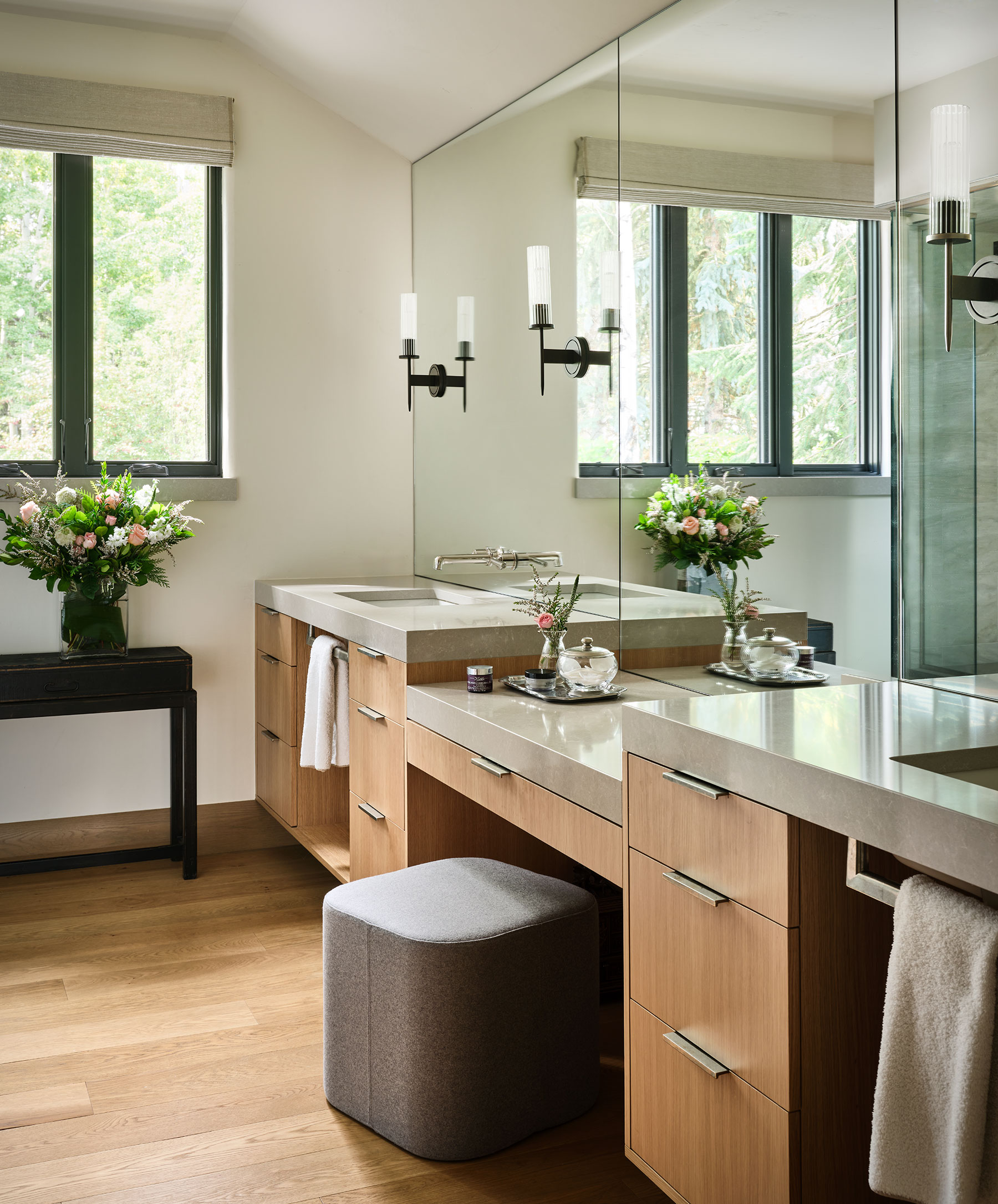 Modern bathroom with oak flooring, cabinets and quartz counters.
