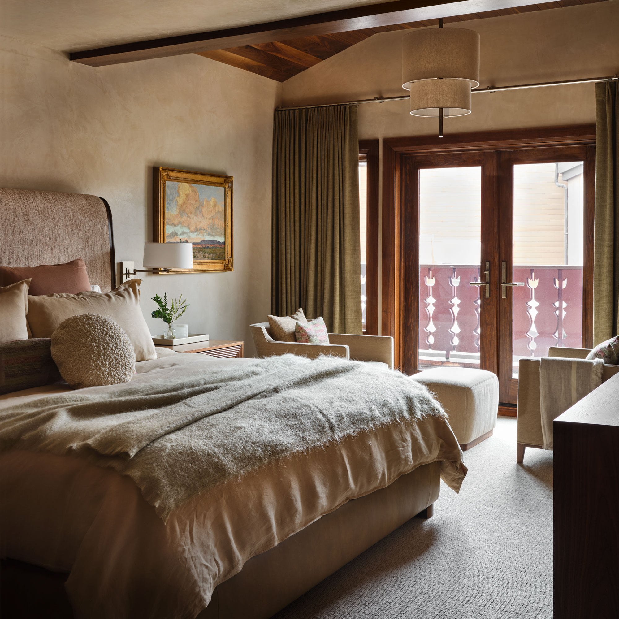 Guest bedroom with glass doors that lead to the outdoor balcony