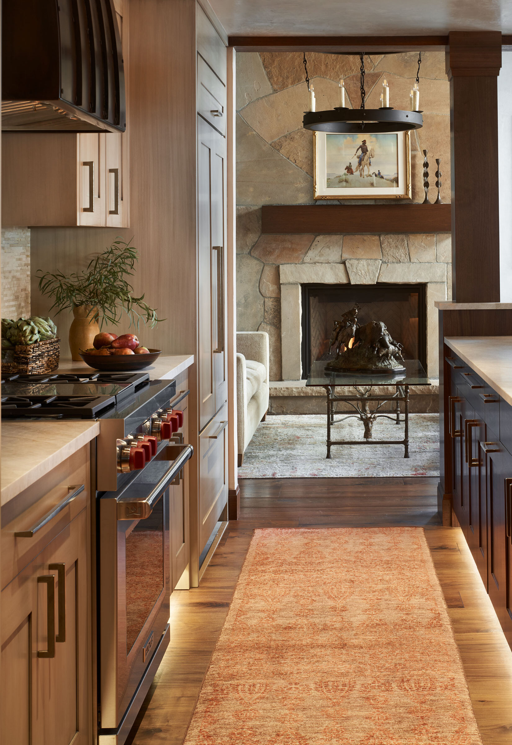 Kitchen with living room stone fireplace in the background